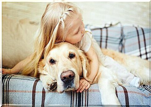 girl hugging dog